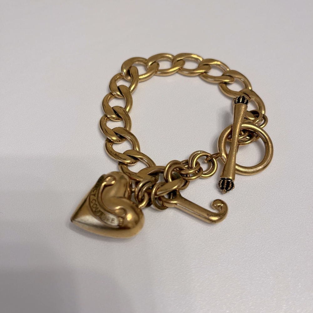 Juicy Couture gold color bracelet. Not new. Some wears , see pictures